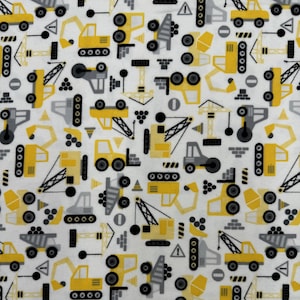 1242 Flannel fabric white with yellow & black tossed construction vehicles sold by the yard.