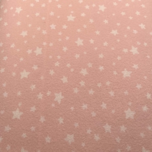 1153 Flannel fabric light pink with white stars sold by the yard.