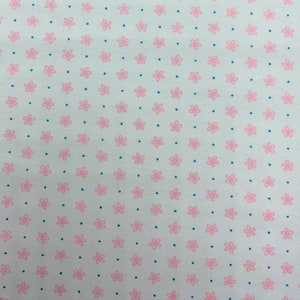779 Flannel fabric white background with little pink daisies and tiny teal dots sold by the yard.