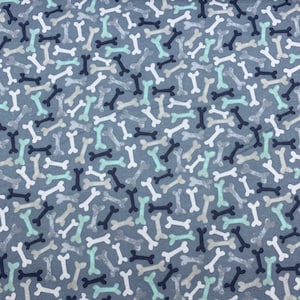 763 Flannel fabric gray background with tossed black gray white mint dog bones sold by the yard.