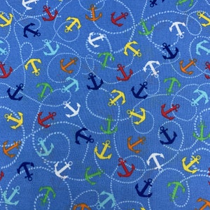 225 COTTON fabric light blue background with tossed anchors and ropes in red yellow orange blue and white anchors sold by the yard.
