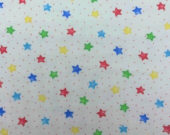 809 Flannel fabric white background tiny red dots with multi color stars sold by the yard.