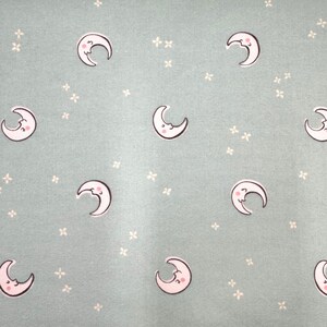 1232 Flannel fabric light mint green background with tossed white crescent moons & stars sold by the yard