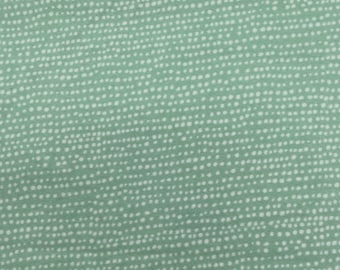 1160 Flannel fabric mint green background with white irregular dots sold by the yard.