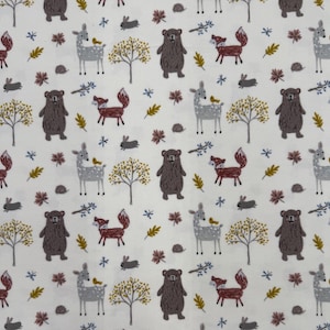 1341 Flannel fabric cream with forest animals trees & leaves sold by the yard.