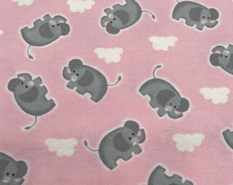1206 Flannel fabric pink background with tossed gray elephants & white clouds sold by the yard.