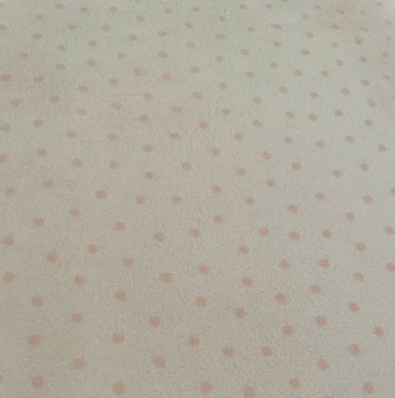 1175 Flannel Fabric Light Peach Background With Peach Dots Sold by