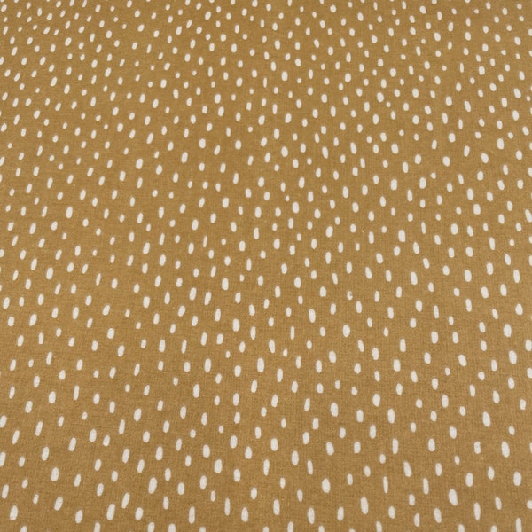 1196 Flannel fabric caramel color background with white raindrops sold by the yard.