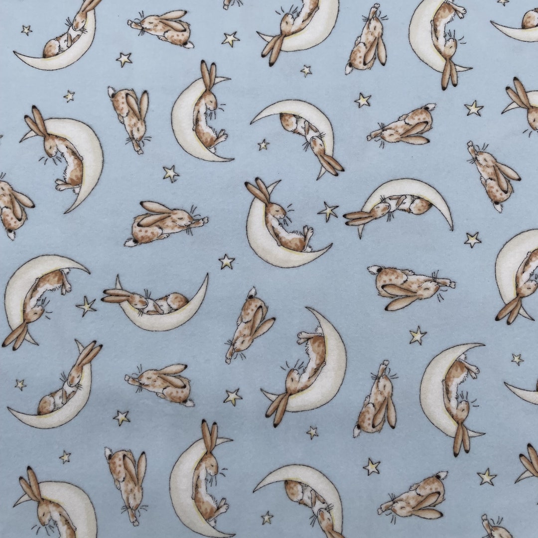 1100 Flannel Fabric Powder Blue Background With Tossed Brown Sleeping