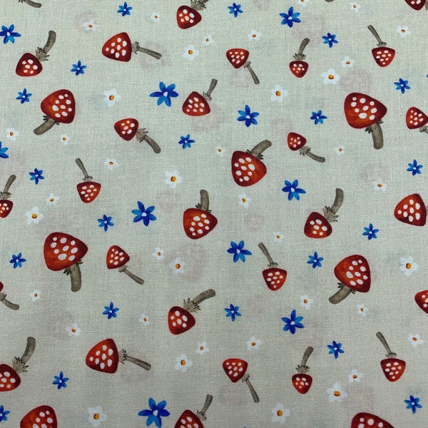 337 COTTON fabric ecru background with tossed mushrooms red with white polka dots and blue and white flowers sold by the yard.