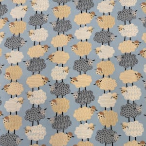1304 Flannel fabric blue with rows of gray beige & white lambs sold by the yard.