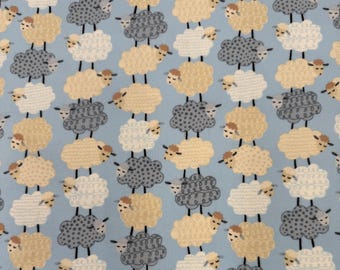 1304 Flannel fabric blue with rows of gray beige & white lambs sold by the yard.