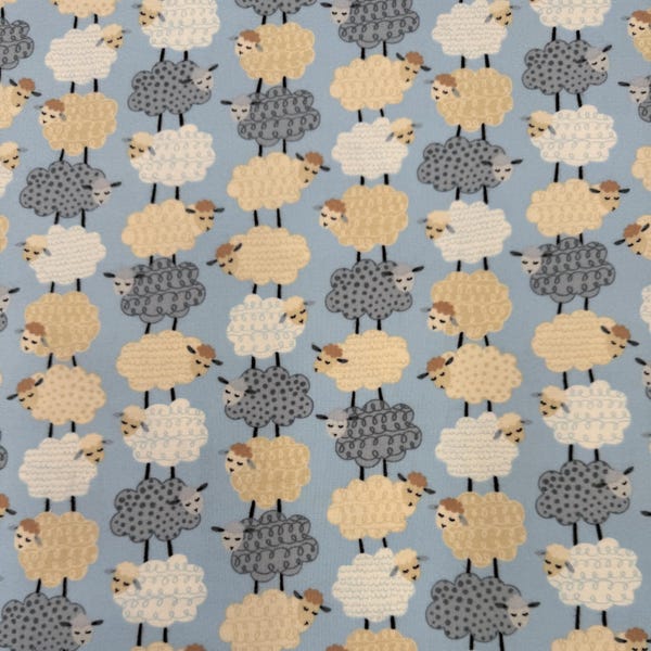 1304 Flannel fabric blue with rows of gray beige & white lambs sold by the yard.