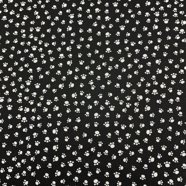 252 - COTTON fabric black background with tossed white paw prints sold by the yard.