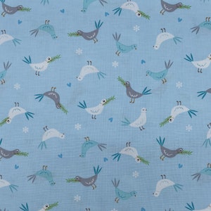 684 COTTON fabric blue background with tossed gray & white doves holding olive branches sold by the yard.