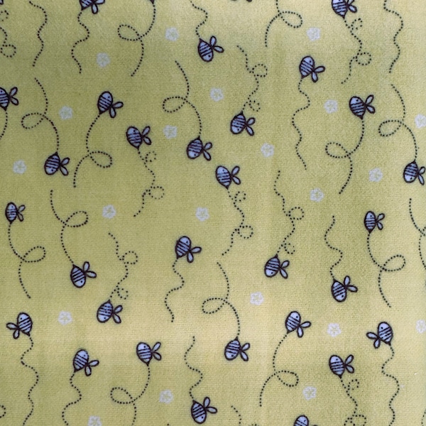 1219 Flannel fabric bright yellow background with blue bumble bees buzzing sold by the yard.