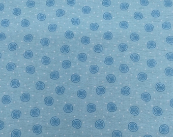 May include: A blue fabric with a white and blue swirl pattern. The fabric has a subtle texture.