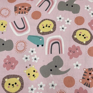 753 COTTON fabric pink with tossed animal faces rainbows flowers sold by the yard.