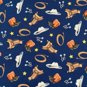 443 COTTON fabric navy blue background with tossed cowboy hats boots saddles spurs stars sold by the yard.