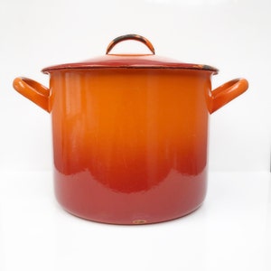 May include: Orange and red enamel pot with a lid and two handles.