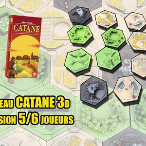 May include: A board game setup with a red box labeled "CATANE" and various hexagonal terrain tiles. The text "Plateau CATANE 3d EXTENSION 5/6 JOUEURS" is displayed. The game pieces include land, sea, and resource tiles.