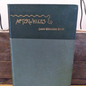 May include: A green hardcover book with the title "Afterwhiles" in gold lettering and the author "James Whitcomb Riley" printed below the title.