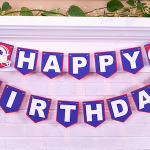 May include: A blue and red banner with the words "Happy Birthday" in white letters. The banner has a football helmet with a buffalo silhouette on each end.