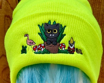 Black tabby cat hiding in the garden  meme yellow  Cuffed knit Beanie