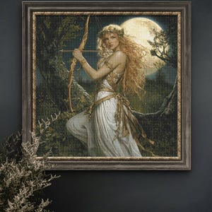 May include: Framed artwork depicting a woman with long blonde hair, holding a bow and arrow, set against a backdrop of a full moon and forest. The woman wears a white dress and a laurel wreath. The frame is a dark wood with gold accents.