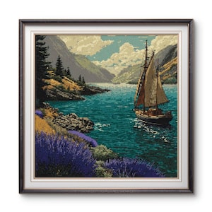 May include: Framed artwork showing a sailboat on a lake with mountains in the background. The water is turquoise, and the sky has white clouds. Lavender bushes are on the shore. The frame is dark brown.