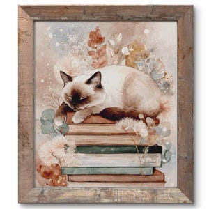 May include: A framed watercolor print of a sleeping cat atop a stack of books. The cat has brown and cream-colored fur. The books are various colors, including brown, green, and cream. The background features floral elements in muted tones.