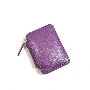 May include: A small purple leather zippered wallet.