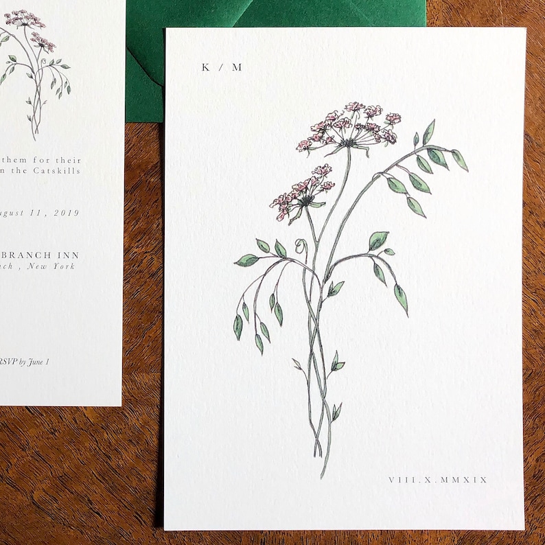 May include: A wedding invitation with a delicate illustration of pink flowers and green leaves. The text on the invitation reads "K/M" and "VIII.X.MMXIX".