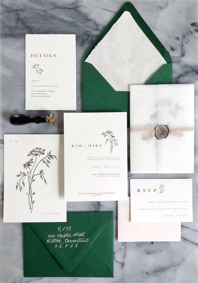 May include: Wedding invitation suite with green envelopes, white and cream cardstock, and a wax seal. The invitation features a floral illustration and the text "KIM and MIKE". The RSVP card includes the text "RSVP" and "kindly respond by the fifteenth of July".