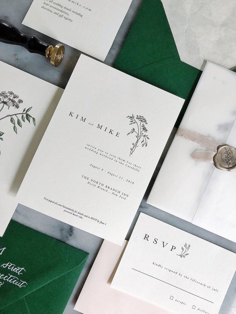 May include: A wedding invitation suite with a green envelope, a white RSVP card, and a white invitation card with the text "KIM and MIKE" and a floral illustration. The invitation card also includes the text "invite you to join them for their wedding weekend in the Catskills August 9 - August 11, 2019 THE NORTH BRANCH INN North Branch, New York Visit population.com/kimandmike for details and to RSVP by June 1!"