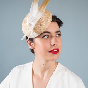 Goldie Beautiful Bridal Headpiece featuring gold tipped feathers and silk tie on a natural straw button base image 3