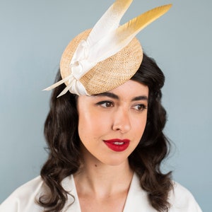 Goldie Beautiful Bridal Headpiece featuring gold tipped feathers and silk tie on a natural straw button base image 7