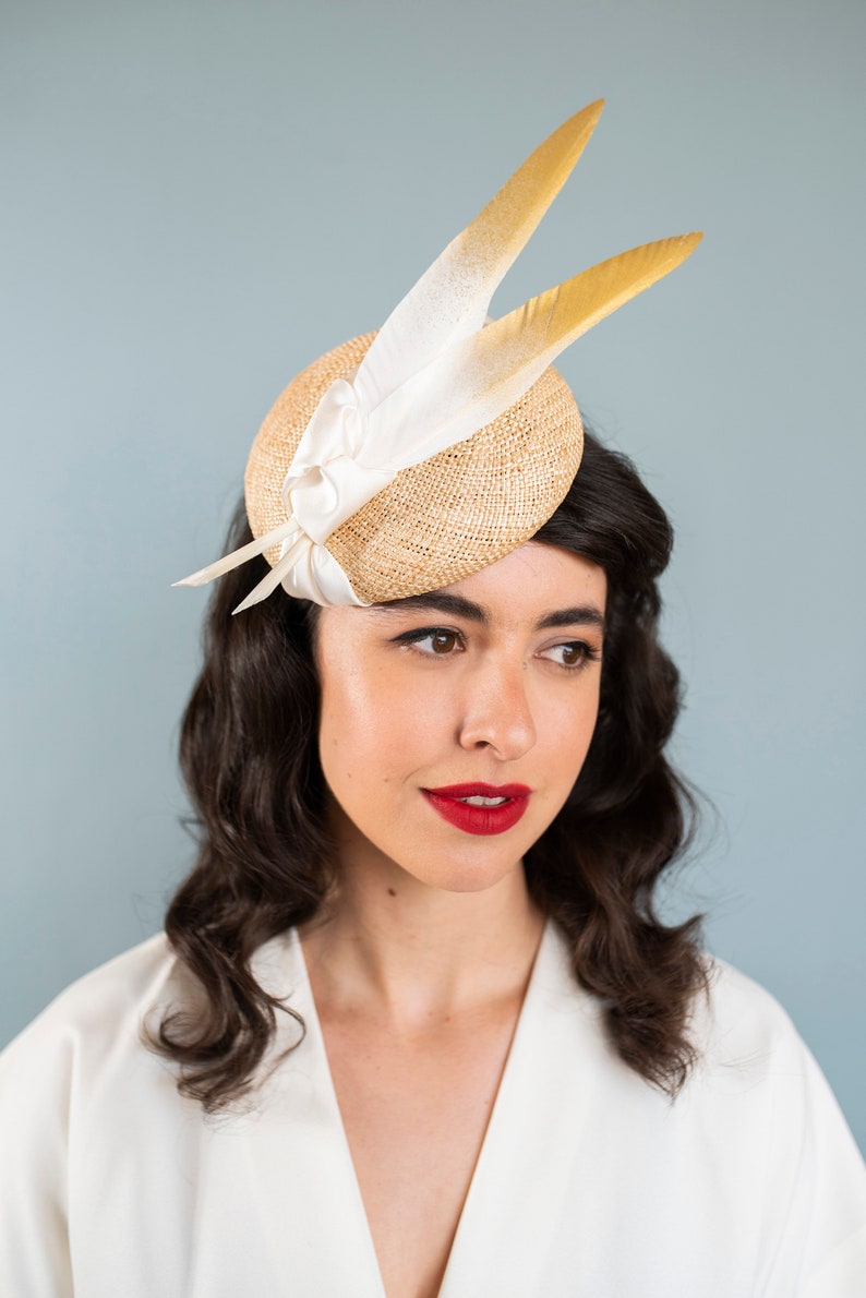 Goldie Beautiful Bridal Headpiece featuring gold tipped feathers and silk tie on a natural straw button base image 7