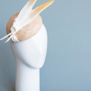 Goldie Beautiful Bridal Headpiece featuring gold tipped feathers and silk tie on a natural straw button base image 8