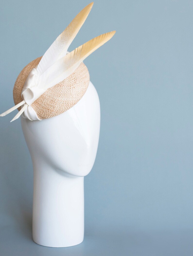 Goldie Beautiful Bridal Headpiece featuring gold tipped feathers and silk tie on a natural straw button base image 8