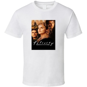May include: White t-shirt with a black and white image of three people and the text "felicity" in white.