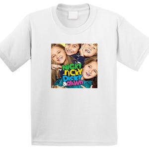 May include: White t-shirt featuring a colorful graphic of four smiling children with the text "Nicky, Ricky, Dicky & Dawn". The graphic is centered on the front of the shirt, which has a crew neck and short sleeves.
