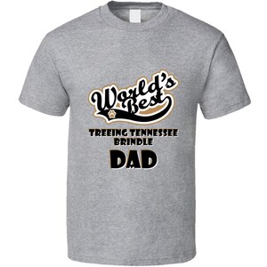 May include: Gray t-shirt with black text that reads "World's Best Treeing Tennessee Brindle Dad" with a paw print graphic.