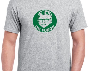 May include: A light gray t-shirt featuring a green circular graphic with a boy wearing glasses and the words "OH FUDGE". The graphic is centered on the front of the shirt. The shirt has short sleeves and a crew neck.