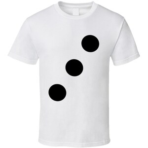 May include: White t-shirt featuring three large black circles arranged vertically. The simple design is centered on the front of the shirt. The t-shirt has short sleeves and a crew neck.