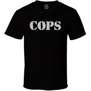 May include: Black t-shirt with the word "COPS" printed in white on the front.