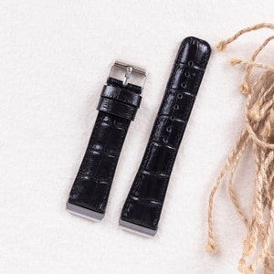 May include: Two black leather watch straps with silver buckles. The straps have a crocodile pattern.