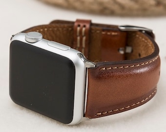 Könnte beinhalten: Ein braunes Lederarmband mit weißen Nähten für eine Apple Watch.
