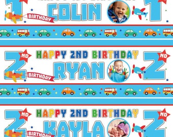 May include: Three blue and white birthday banners with red, yellow, and green accents. The banners feature the numbers 1, 2, and 2, along with the words "Happy 1st Birthday Colin", "Happy 2nd Birthday Ryan", and "Happy 2nd Birthday Kayla". Each banner has a photo of a child and a small airplane with a red propeller.
