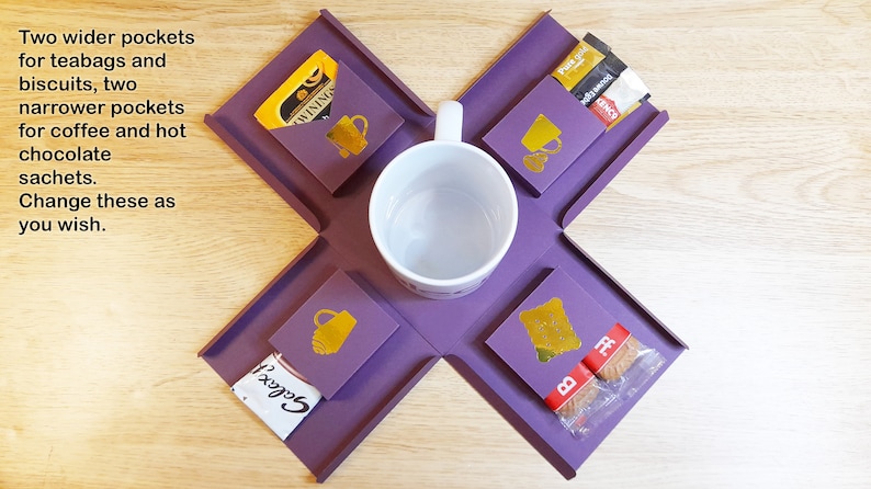 May include: Purple tray with four compartments for holding a mug, tea bags, coffee packets, and biscuits. The tray is made of a flexible material and folds flat for storage. The text "WININGS" and "Gocci" are visible on the packaging.